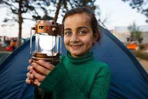 Ein lächelndes Mädchen hält eine Lampe. ©David Lohmüller